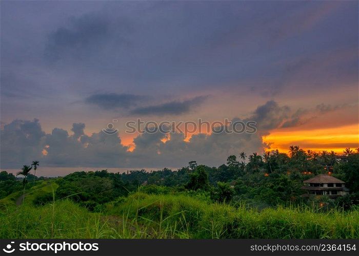 Indonesia. Rainforest and house at the evening. Beautiful clouds on the horizon. Evening Clouds over Rainforest
