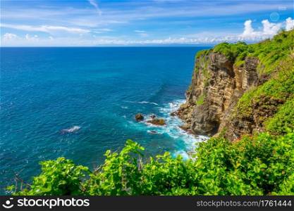 Indonesia. Rocky Coast of a Tropical Island and Sunny Day.