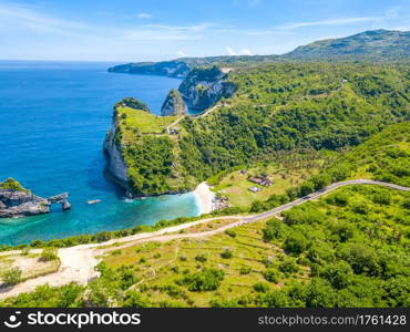 Indonesia. Rocky coast of the tropical island of Penida and a small beach. Aerial view. Rocky Coast of a Tropical Island. Aerial View