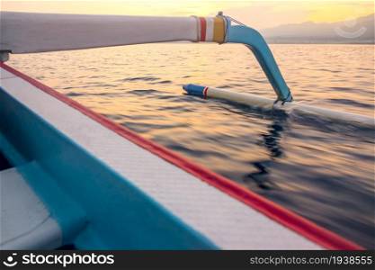 Indonesia. Sea dawn. Traditional Indonesian boat and outrigger. Float of the Indonesian Trimaran in the Morning Sea