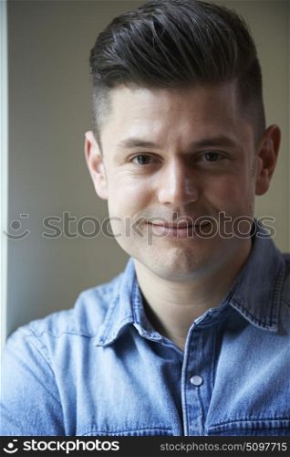 Indoor Head And Shoulders Portrait Of Smiling Man