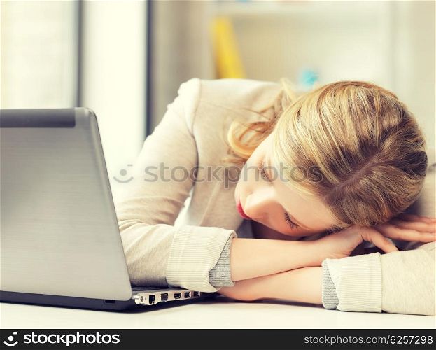 indoor picture of bored and tired woman sleeping on the table. bored and tired woman sleeping on the table