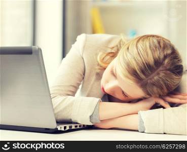 indoor picture of bored and tired woman sleeping on the table. bored and tired woman sleeping on the table