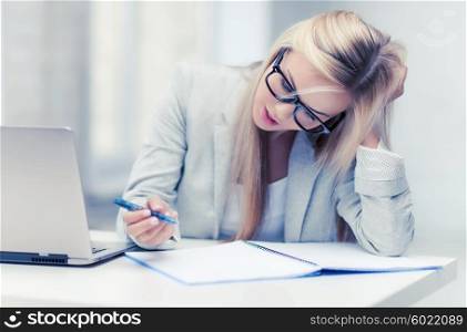 indoor picture of bored and tired woman taking notes. bored and tired woman