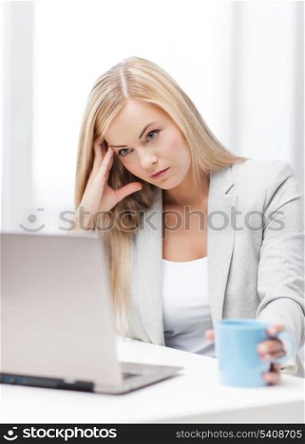 indoor picture of bored and tired woman with laptop
