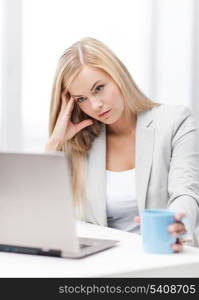 indoor picture of bored and tired woman with laptop