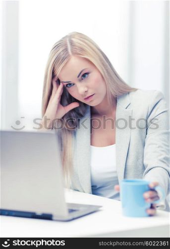 indoor picture of bored and tired woman with laptop. bored and tired woman