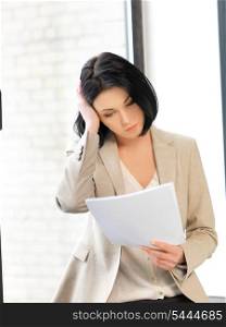 indoor picture of calm woman with documents