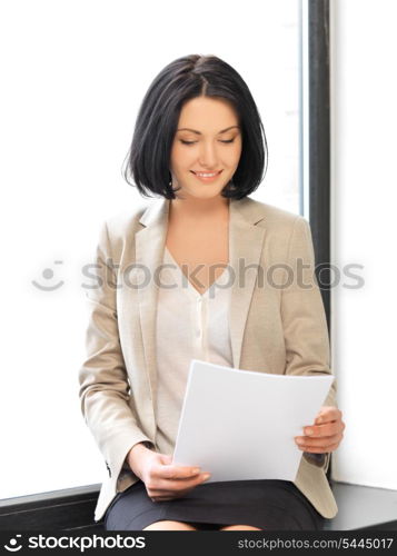 indoor picture of happy woman with documents