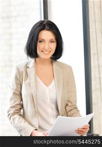 indoor picture of happy woman with documents