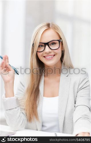 indoor picture of happy woman with documents and pen