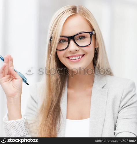 indoor picture of happy woman with documents and pen. businesswoman with documents