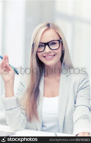 indoor picture of happy woman with documents and pen. businesswoman with documents