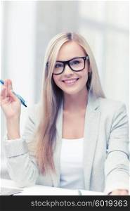 indoor picture of happy woman with documents and pen. businesswoman with documents