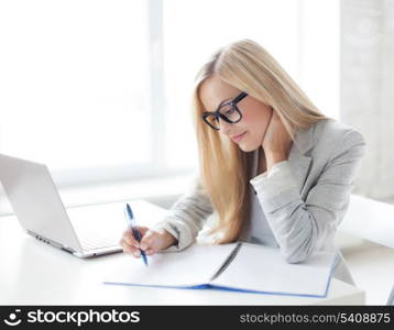 indoor picture of smiling woman with documents and pen