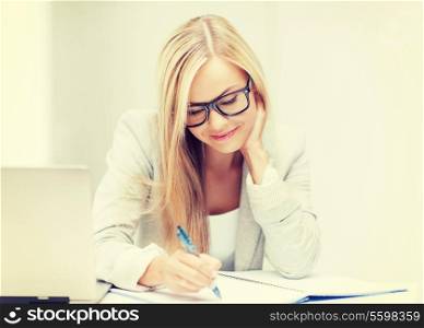 indoor picture of smiling woman with documents and pen
