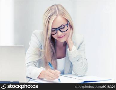 indoor picture of smiling woman with documents and pen. businesswoman with documents