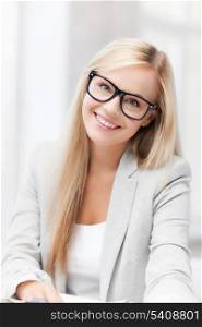 indoor picture of smiling woman with eyeglasses