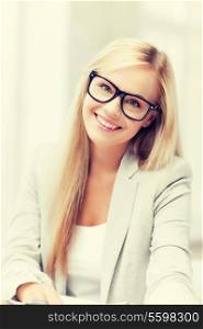 indoor picture of smiling woman with eyeglasses