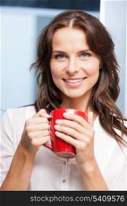 indoor picture of smiling woman with red cup