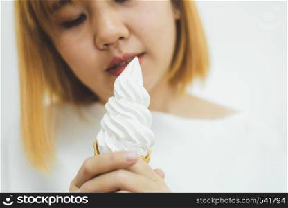 Indoor portrait of young beautiful asian woman eating ice cream in summer. Woman hands holding melting ice cream waffle cone. lifestyle asia woman concept