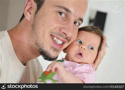 indoor portrait with happy young famil and cute little babby