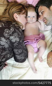 indoor portrait with happy young family and cute little babby