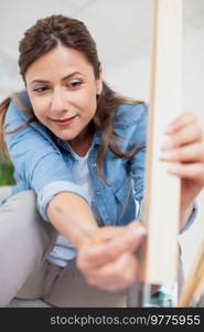 indoor shot of young woman diy at home