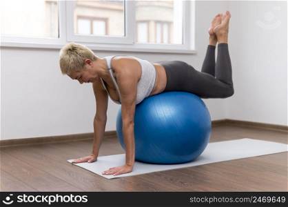 indoors doing exercises with fitness ball
