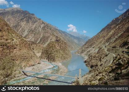 Indus river flowing through mountains in rural area of Pakistan. View from Karakoram highway.