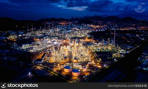 industrial area oil and gas products refinery plants and stores pipeline at night over lighting with blue sky background in Thailand