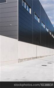 Industrial building facade with metallic cladding. Industrial warehouse. Construction elements of modern architecture