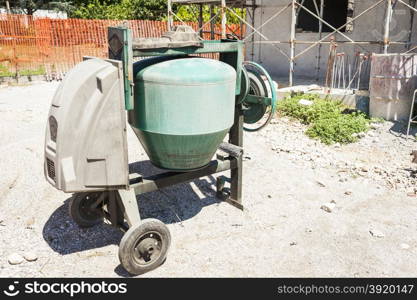 Industrial cement mixer machinery at construction site.