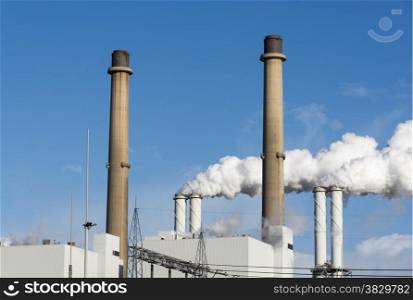 industrial chimney with lot of environment pollution
