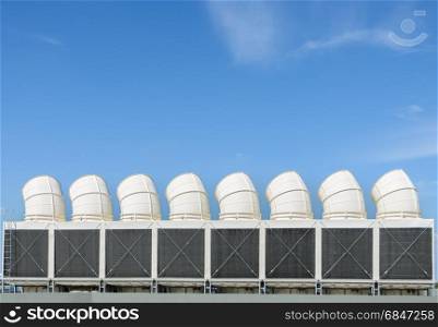Industrial cooling towers or air cooled chillers . Industrial cooling towers or air cooled chillers on building rooftop