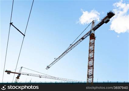 industrial crane under blue sky in summer evening