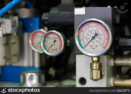Industrial equipment with pressure gauge meters. Selective focus