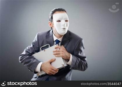 Industrial espionate concept with masked businessman