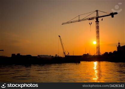 Industrial harbor, port at sunset and a crane