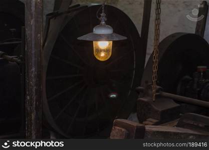 Industrial interior of an old factory. Focus on a lamp