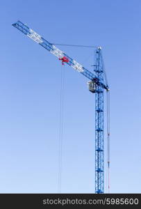 Industrial landscape with silhouettes of cranes on the sky background