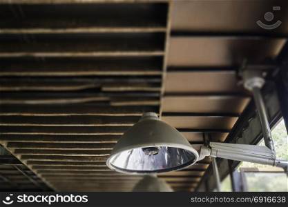 Industrial light lamp with grunge rusty ceiling, stock photo