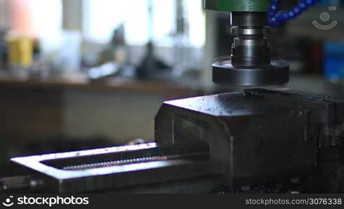 Industrial metal machining cutting process. Old lathe machine cutting metal detail by milling cutter rotating head with drilling machine bits and tools in a high precision mechanics in workshop.