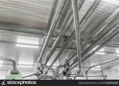 Industrial metal pipes along the ceiling, ventilation system. pipes and ducts in the plant
