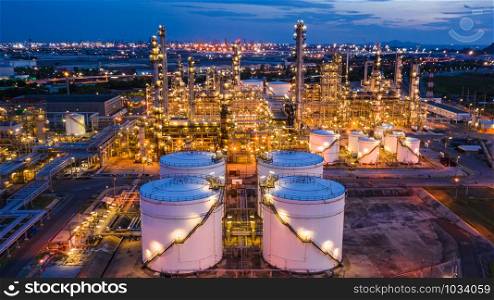 industrial oil and gas LPG refinery industry and commercial storage facilities import and export international by sea transport vessels aerial view at night in Thailand