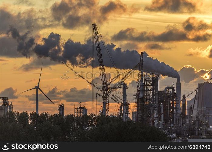 Industrial Pollution - An industrial skyline at dusk - Rotterdam in the Netherlands.