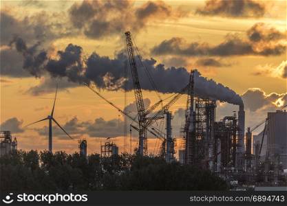 Industrial Pollution - An industrial skyline at dusk - Rotterdam in the Netherlands.