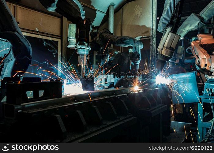 Industrial robot are movement welding steel part in factory