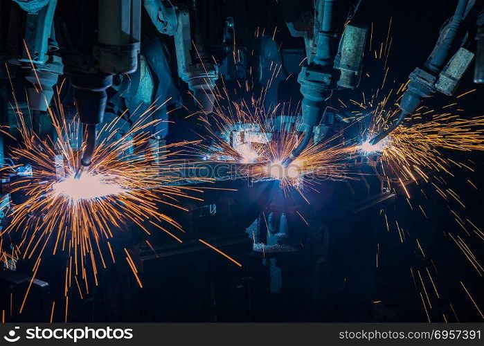 Industrial robots are welding in factory