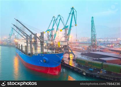 Industrial ship in Batumi port in the rainy evening. Georgia
